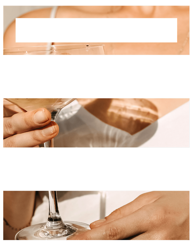 Person holding a cocktail glass, stylish setting.